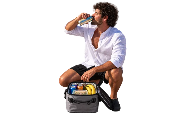 Man with slightly longer curls enjoying a drink beside a tidy upright CLEVEREE cooler